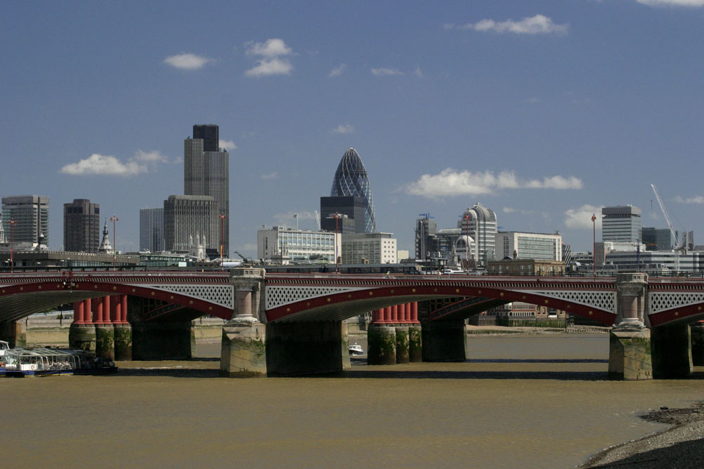 A view along the Thames to the city taking in the Nat West Tower and the Swiss Re Tower.
